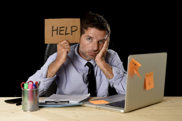 A man holding up a sign that says help.