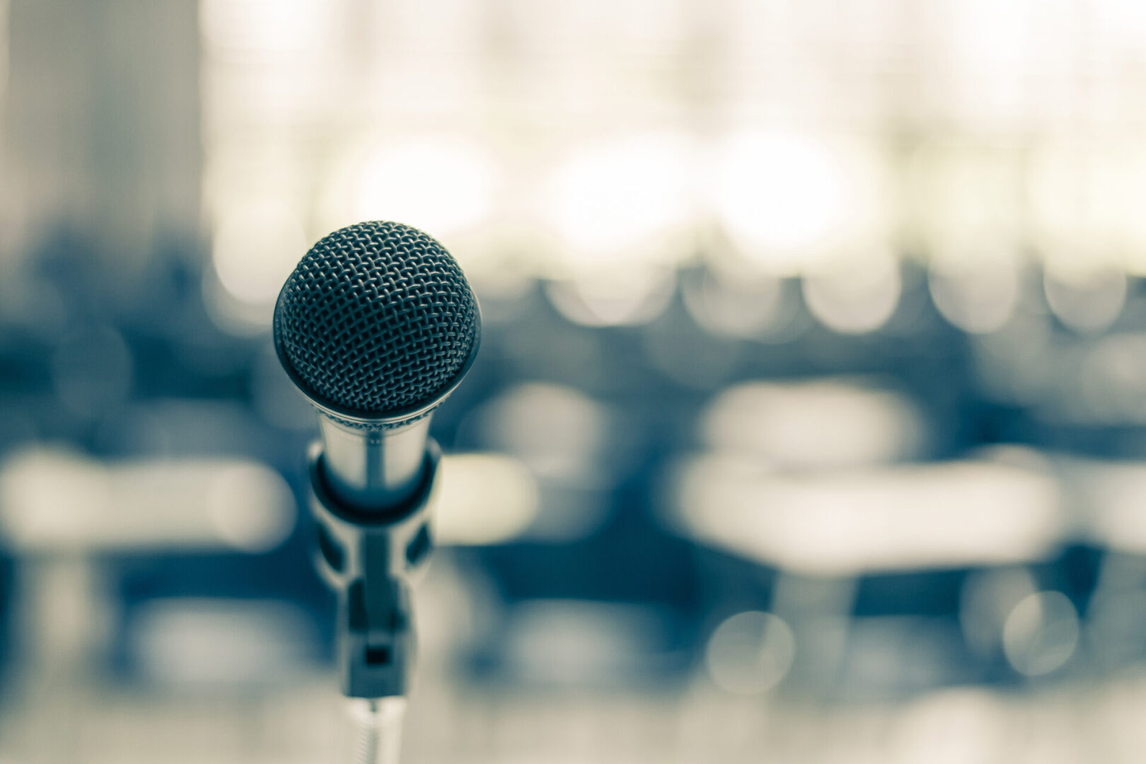 A microphone on a stand in a room.