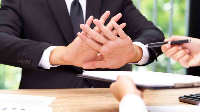 Man refusing to sign a document.
